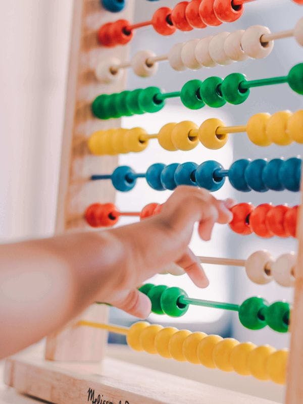 Child playing with abacus